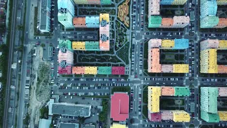 view-from-above-on-a-bright-colorful-district,-colorful-houses-and-roads-filled-with-cars