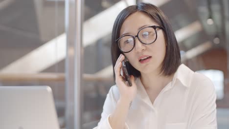 Busy-Female-Office-Worker-Having-Phone-Call