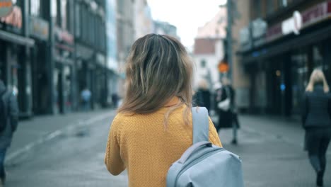 A-lady-with-a-map-is-looking-around-a-city-street