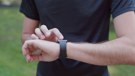 Young-man-trying-new-smart-watch.-Smart-watch.-Man-Using-Smart-Watch.-Closeup