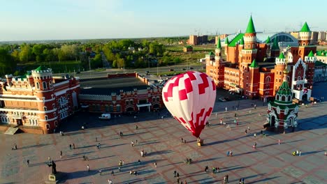 Balloon-is-rising-at-city-square.-Video,-flight-above-Yoshkar-Ola,-Russia