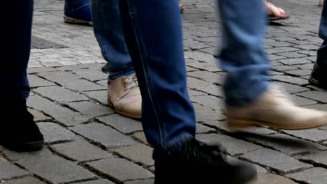 Lot-of-feet-a-crowd-of-people-strolling-along-the-cobbles-of-the-city