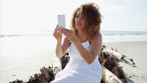 Plus-size-African-American-female-sitting-on-beach