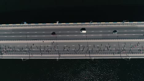 4K-Aerial-drone-fooage.-Marathon-running-on-the-bridge.-Horizontal-movement-dolly-shot-top-view