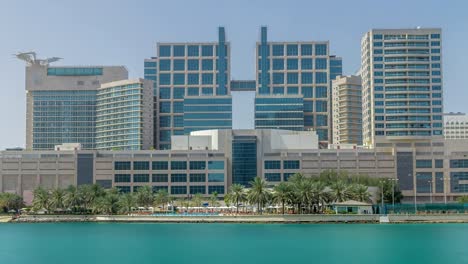 Modern-buildings-in-Abu-Dhabi-skyline-timelapse-with-mall-and-beach