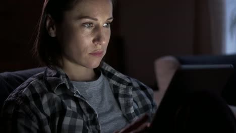 Woman-using-digital-tablet-at-night