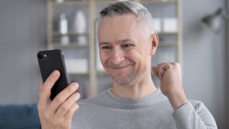 Excited-Gray-Hair-Man-Winning-Online-on-Tablet