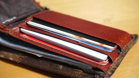 Open-leather-brown-wallet-with-credit-and-discount-cards-4K