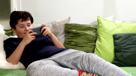 Portrait-of-a-young-boy-paying-video-games-at-home