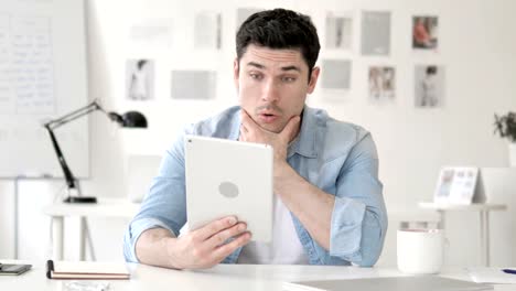 Casual-Young-Man-in-Shock-while-Using-Tablet