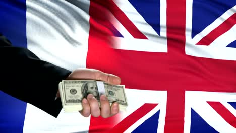 France-and-Great-Britain-officials-exchanging-tank-for-money,-flag-background