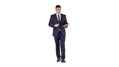 Businessman-walking-and-swiping-pages-on-his-tablet-computer-and-looking-to-camera-presenting-something-on-white-background