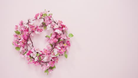 pink-silk-flower-wreath-on-a-pink-background.