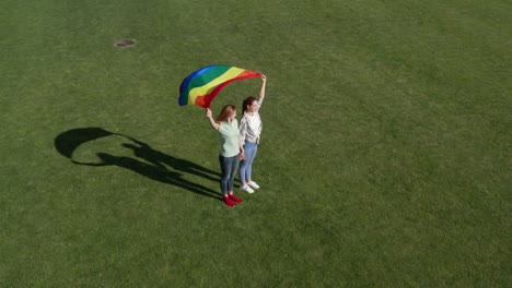 Aerial-view-of-lgbt-couple-holding-rainbow-flag