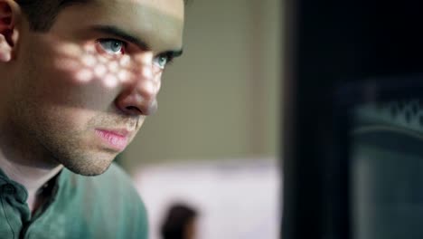 Closeup-of-concentrated-young-technician-carefully-observing-work-of-3d-printing-machine-in-laboratory