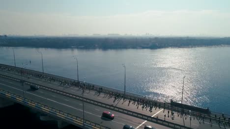 Marathon-running-on-the-bridge.-Dolly-shot