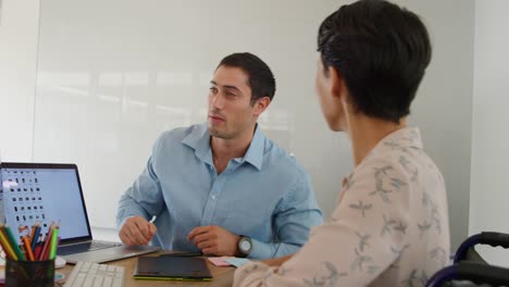 Young-man-and-woman-working-in-a-creative-office