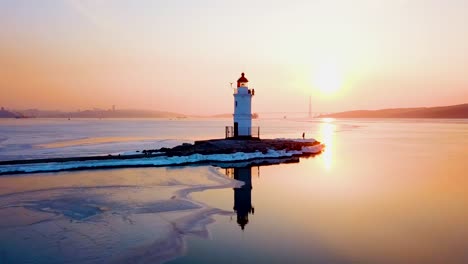 Aerial-winter-view-of-the-Tokarevskiy-lighthouse---one-of-the-oldest-lighthouses-in-the-Far-East,-still-an-important-navigational-structure-and-popular-attractions-of-Vladivostok-city,-Russia.