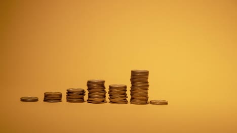 Rows-of-money-coins-on-gold-background