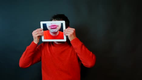 Close-up-of-male-lips-on-tablet-screen.