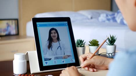 4K.-sick-woman-use-video-conference,-make-online-consultation-with-doctor-via-tablet,-patient-ask-doctor-about-illness-and-medication-via-video-call.-Telehealth,-Telemedicine-and-online-hospital