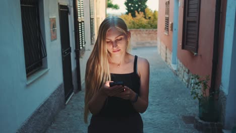 Woman-reading-something-on-smartphone-while-walking-the-street