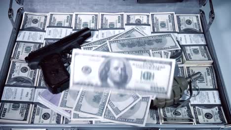 Case-full-of-dollars,-with-american-machine-gun.