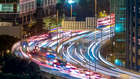 Top-view-of-busy-traffic-night-in-finance-urban-timelapse,-hong-kong-city