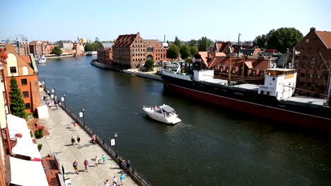 Beautiful-white-yacht-sailing-on-Motlawa-river-in-Gdansk,-water-transportation