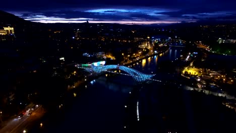 Bridge-of-Peace-in-Tbilisi,-captured-from-bird-eye-view,-LED-ray-brightness