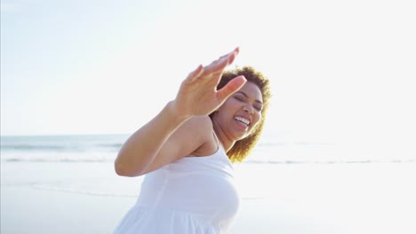 Portrait-of-African-American-female-waving-by-ocean