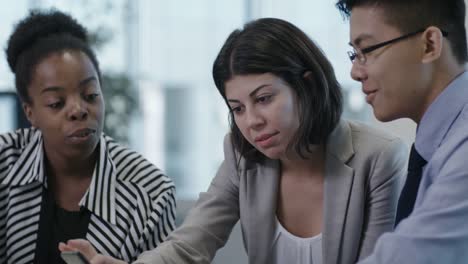 Multi-Ethnic-Coworkers-Chatting-and-Using-Smartphone