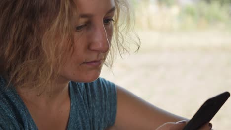 Close-up-portrait-female-messaging-cellular.