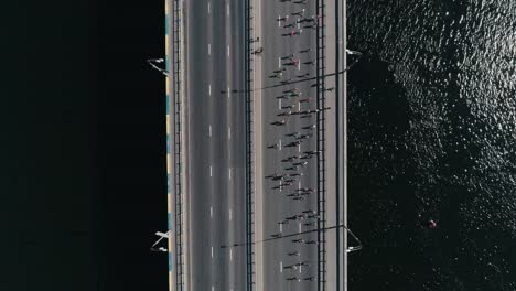 Marathon-running-on-the-bridge.-Vertical-dolly-shot-top-view-slow-motion