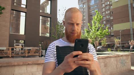 ginger-guy-scrolling-touch-screen-phone