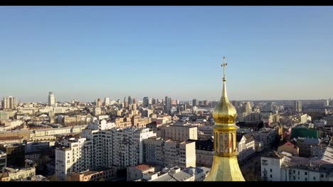 A-bird's-eye-view,-panoramic-video-from-the-drone-in-FullHD-to-the-golden-dome-Saint-Sophia's-Cathedral,-Maidan-Nezalezhnosti,-left-bank-of-city-Kiev,-Ukraine.