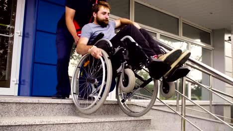 Man-helping-to-move-down-to-a-disabled-man