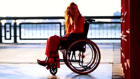 Beautiful-Red-Haired-Girl-In-A-Wheelchair-Takes-Out-Of-The-Shelf-Book