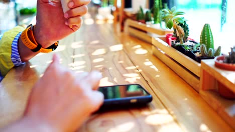 Woman-hand-using-smartphone-in--cafe-background.-Business,-financial,-trade-stock-maket-and-social-network-concept.