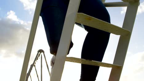 Low-section-of-disabled-woman-climbing-ladder-in-the-park-4k