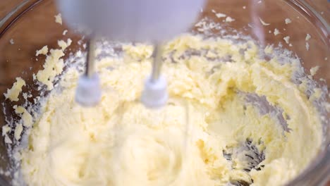 Adding-eggs-to-dough.-Making-cake-in-the-kitchen.