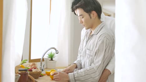 Happy-gay-couple-cooking-together-in-home-kitchen.-People-with-gay,-homosexual,-relationship-concept.