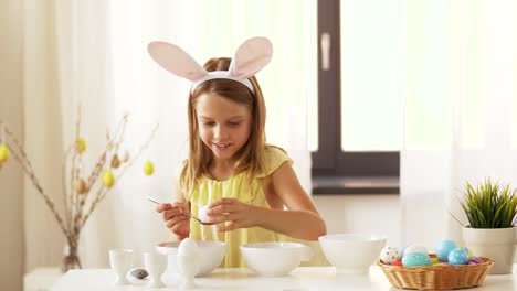 girl-coloring-easter-eggs-by-liquid-dye-at-home