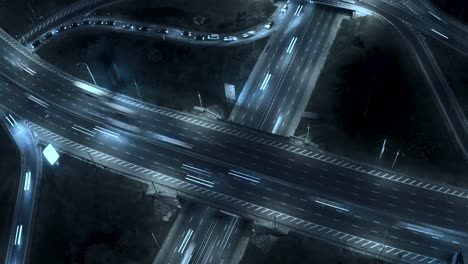 Traffic-on-freeway-interchange.-Aerial-night-view-timelapse-city-traffic.