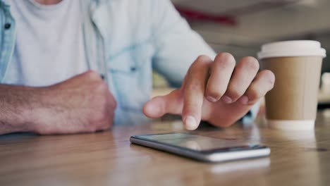 Midsection-Of-Blogger-Using-Smart-Phone-On-Table