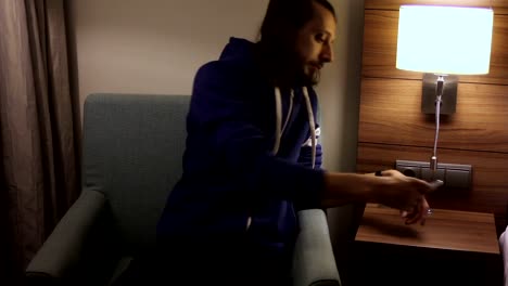 Handsome,-young-man-with-tablet-computer-sitting-on-chair-at-home