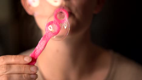 closeup-macro-slow-motion-lips-blowing-bubbles-at-camera