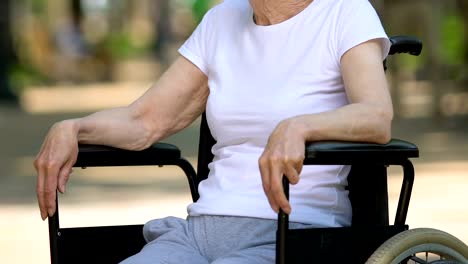 Cheerful-disabled-woman-sitting-in-park-and-breathing-fresh-air,-rehabilitation