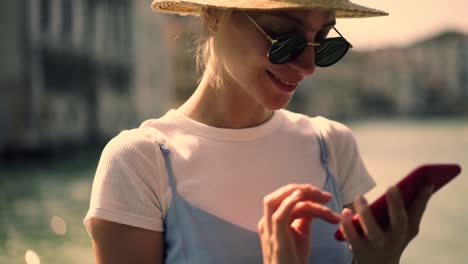 Cheerful-woman-enjoying-boat-excursion-in-Venice-typing-expression-thoughts-in-organiser-application-for-writing-content-text-about-italian-vacations