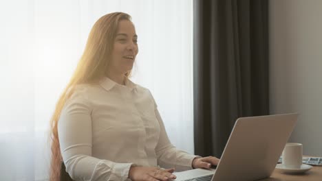 Female-distant-teacher-or-friend-making-video-call-and-talking,-looking-at-laptop-webcam,-online-chat-or-business-conference